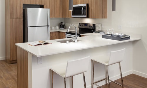 well lit kitchen with open countertop and seating