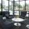 Spacious and well lit lobby with plenty of seating and large windows with a view of the city 