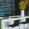 Spacious and well lit lobby with tables and chairs and places to work from home or hang out