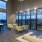 Spacious and well lit lobby with plenty of seating and large windows with a view of the city 