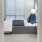 Spacious and well lit bedroom with plush carpet and large windows