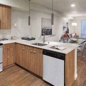 Kitchen  Spacious and well lit kitchen with wood floors and stainless steel appliances.