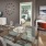 Spacious and well lit living room with wood floors and an open floor plan with access to the kitchen.