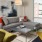 Spacious and well lit living room with wood floors and an open floor plan with access to the kitchen.